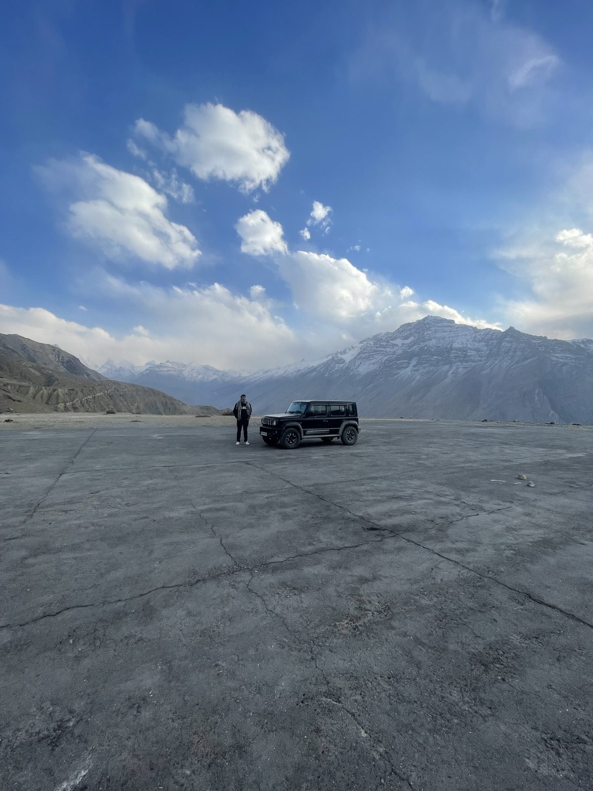 A lone 4x4 on a cracked mountain plateau